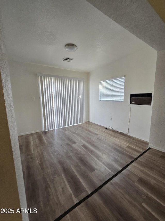 spare room with wood-type flooring