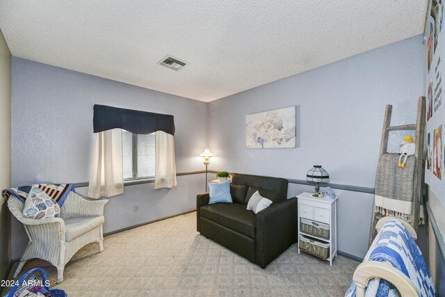 11630 N 74th Dr, Peoria, AZ 85345 - carpeted living room featuring a textured ceiling, baseboards, and visible vents