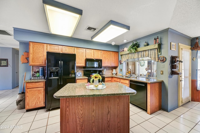 11630 N 74th Dr, Peoria, AZ 85345 - kitchen featuring light tile patterned flooring, a center island, visible vents, black appliances, and decorative backsplash
