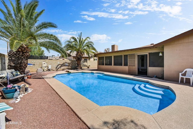 11630 N 74th Dr, Peoria, AZ 85345 - view of swimming pool with a sunroom, fence, a patio, a diving board, and a fenced in pool