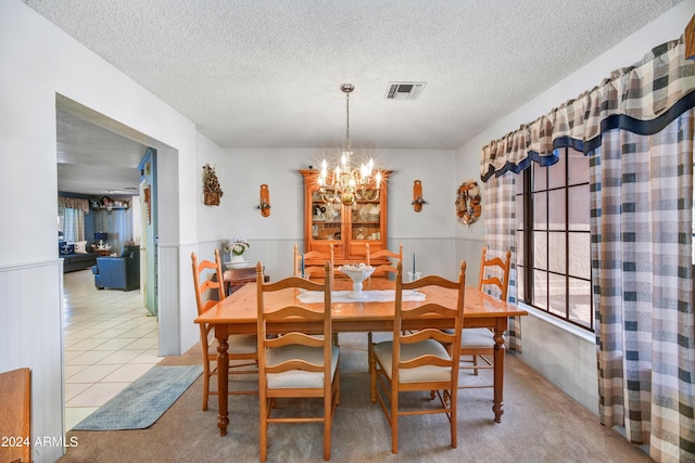 11630 N 74th Dr, Peoria, AZ 85345 - dining area featuring tile patterned flooring, a notable chandelier, a textured ceiling, and visible vents
