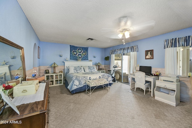11630 N 74th Dr, Peoria, AZ 85345 - carpeted bedroom with a wainscoted wall, a textured ceiling, visible vents, arched walkways, and ceiling fan