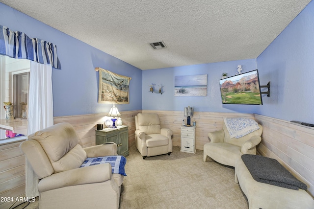 11630 N 74th Dr, Peoria, AZ 85345 - sitting room with wainscoting, visible vents, wood walls, and a textured ceiling
