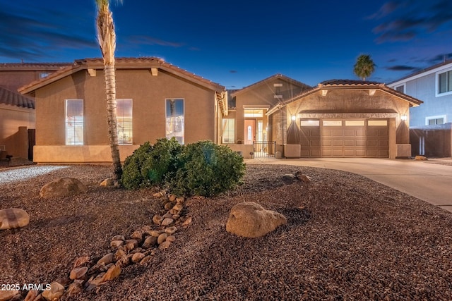 10722 E Keats Ave, Mesa, AZ 85209 - mediterranean / spanish-style home featuring an attached garage, driveway, stucco siding, and a tile roof