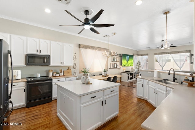 10722 E Keats Ave, Mesa, AZ 85209 - kitchen featuring fridge with ice dispenser, a sink, light wood-type flooring, ceiling fan with notable chandelier, and black electric range