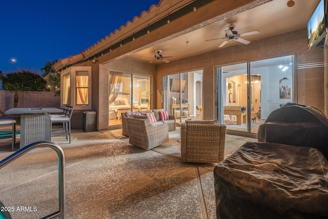 10722 E Keats Ave, Mesa, AZ 85209 - patio at night featuring outdoor lounge area, outdoor dining space, ceiling fan, and fence