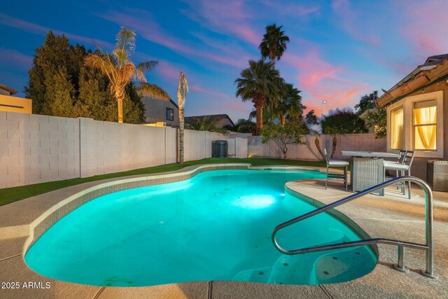 10722 E Keats Ave, Mesa, AZ 85209 - pool at dusk with a patio, a fenced backyard, a fenced in pool, and outdoor dining area