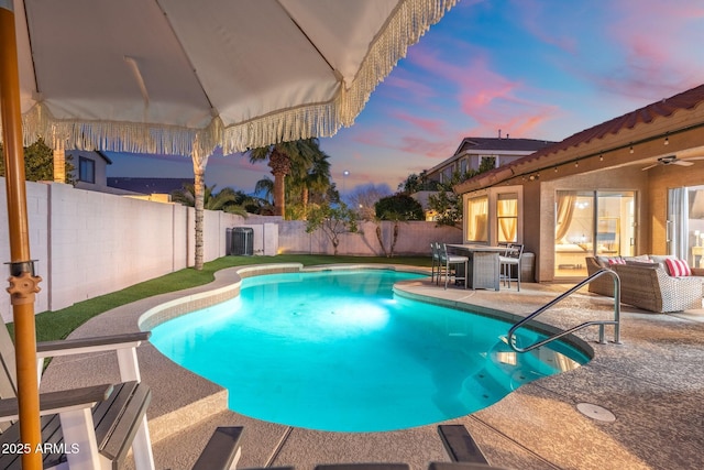 10722 E Keats Ave, Mesa, AZ 85209 - pool at dusk featuring an outdoor living space, a fenced backyard, a patio, outdoor dining space, and a fenced in pool