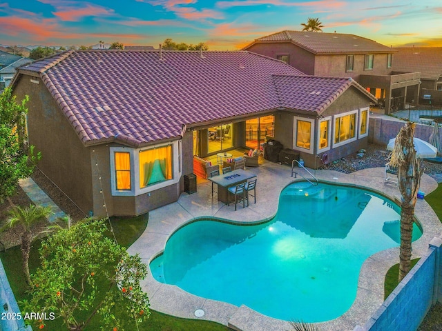10722 E Keats Ave, Mesa, AZ 85209 - pool at dusk with a fenced backyard, outdoor lounge area, a fenced in pool, and a patio