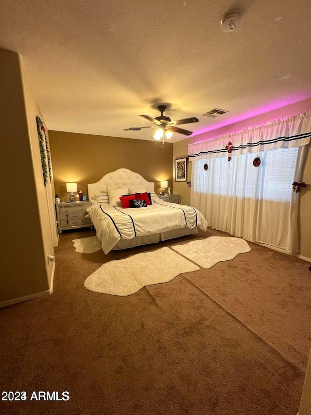 unfurnished bedroom featuring ceiling fan, a textured ceiling, and carpet