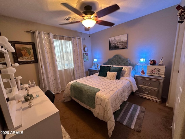 bedroom featuring ceiling fan and dark colored carpet