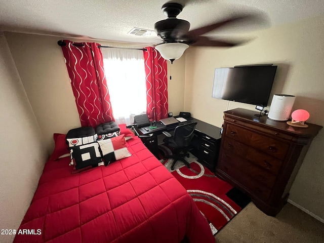 bedroom featuring ceiling fan, carpet flooring, and a textured ceiling