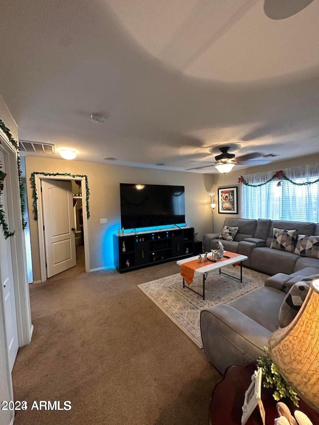 living room with ceiling fan and carpet flooring