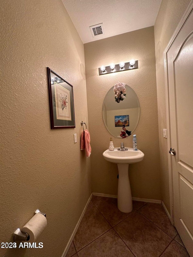 bathroom with tile patterned floors