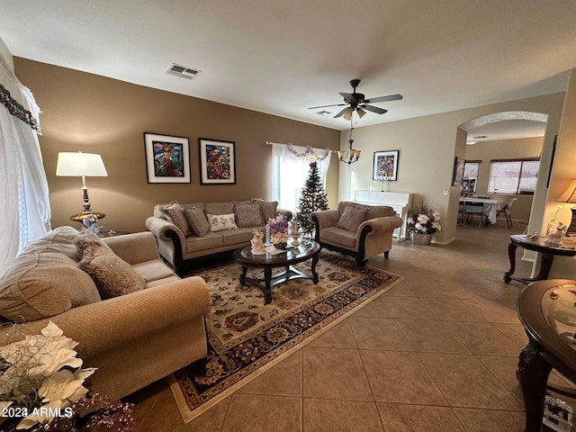 tiled living room with ceiling fan