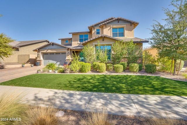 craftsman-style house featuring a garage and a front lawn