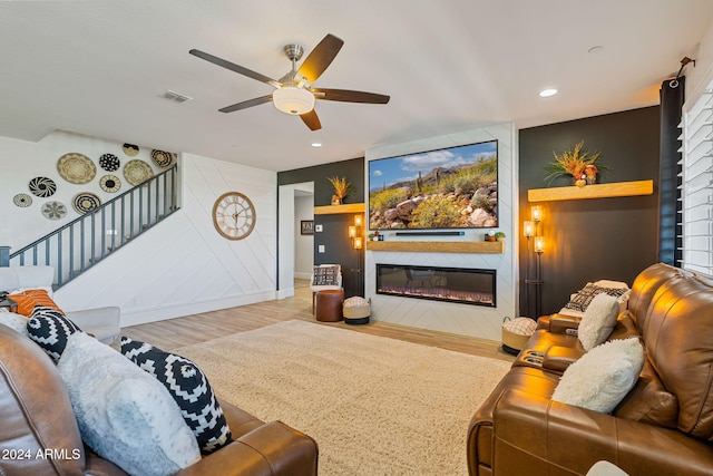 living room with hardwood / wood-style floors and ceiling fan