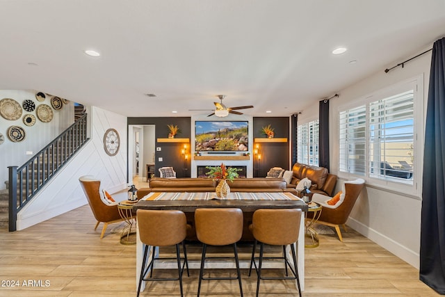 dining space with light hardwood / wood-style floors and ceiling fan