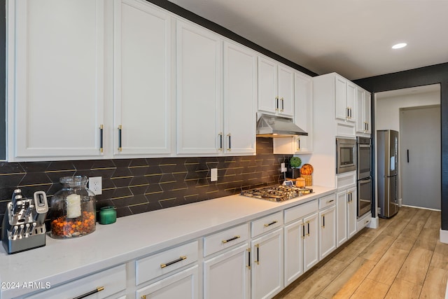 kitchen featuring light hardwood / wood-style flooring, white cabinets, tasteful backsplash, and stainless steel appliances