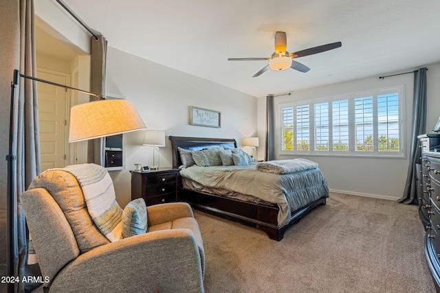 bedroom with ceiling fan and light carpet