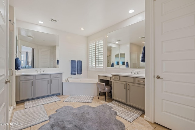 bathroom with vanity, tile patterned floors, and a bathtub