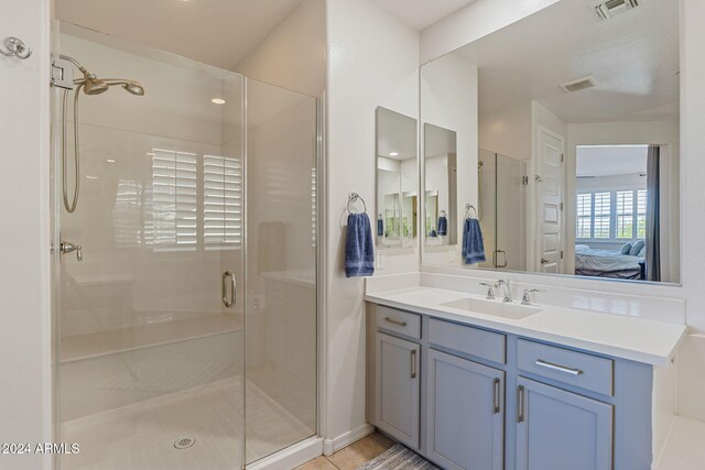 bathroom with vanity, tile patterned floors, and an enclosed shower