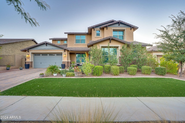 craftsman house featuring a front yard and a garage