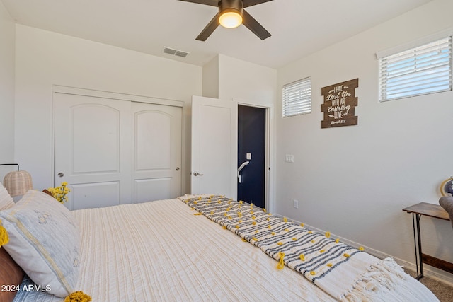 bedroom with carpet, a closet, and ceiling fan