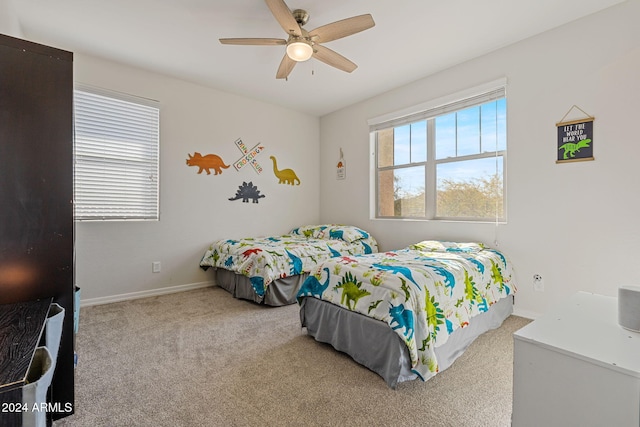 bedroom featuring ceiling fan and light carpet