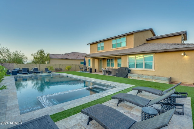 view of swimming pool with an in ground hot tub and a patio