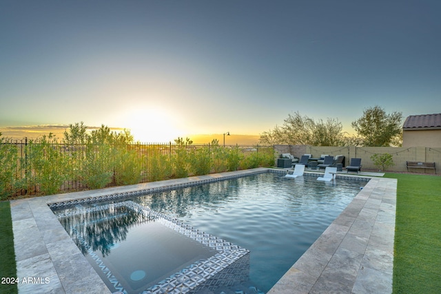 view of pool at dusk