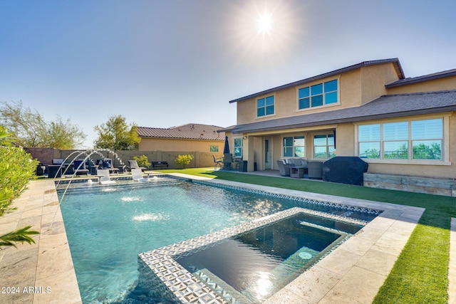 view of pool featuring pool water feature, area for grilling, and a patio