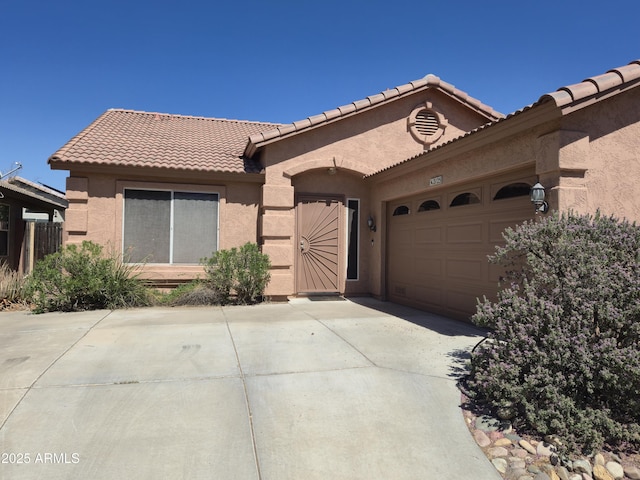 2125 E Danbury Rd, Phoenix, AZ 85022 - view of front of house featuring driveway, stucco siding, a garage, and a tiled roof