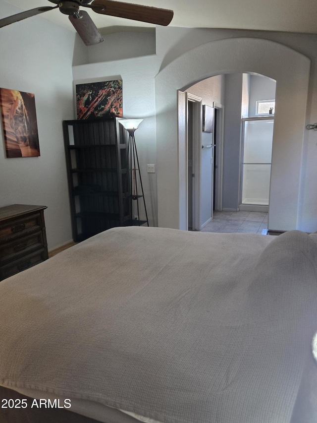2125 E Danbury Rd, Phoenix, AZ 85022 - bedroom with arched walkways, tile patterned floors, and a ceiling fan
