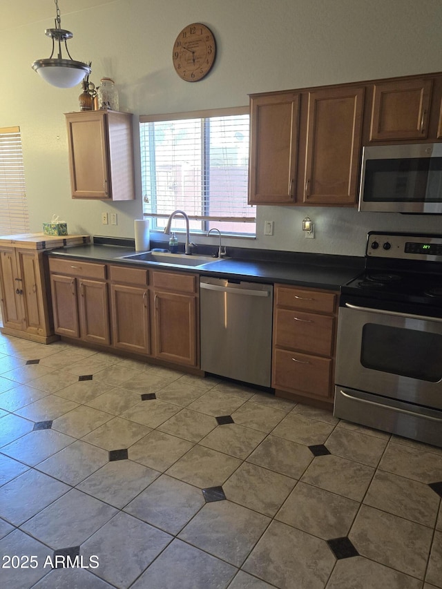 2125 E Danbury Rd, Phoenix, AZ 85022 - kitchen with appliances with stainless steel finishes, dark countertops, and light tile patterned floors