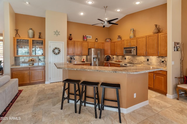 43638 N 22nd St, New River, AZ 85087 - kitchen featuring stainless steel appliances, ceiling fan, decorative backsplash, high vaulted ceiling, and recessed lighting