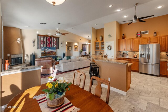 43638 N 22nd St, New River, AZ 85087 - dining space with a ceiling fan, vaulted ceiling, a fireplace, and recessed lighting