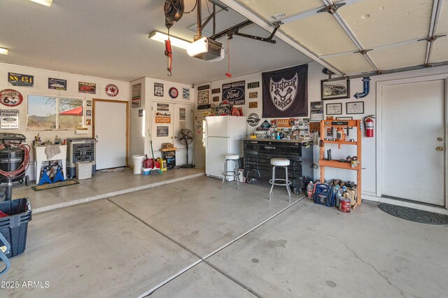 43638 N 22nd St, New River, AZ 85087 - garage with freestanding refrigerator and a garage door opener