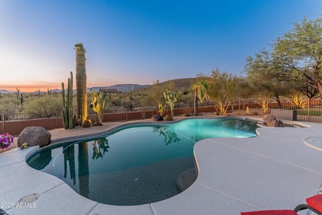 43638 N 22nd St, New River, AZ 85087 - pool at dusk with a fenced backyard and a mountain view