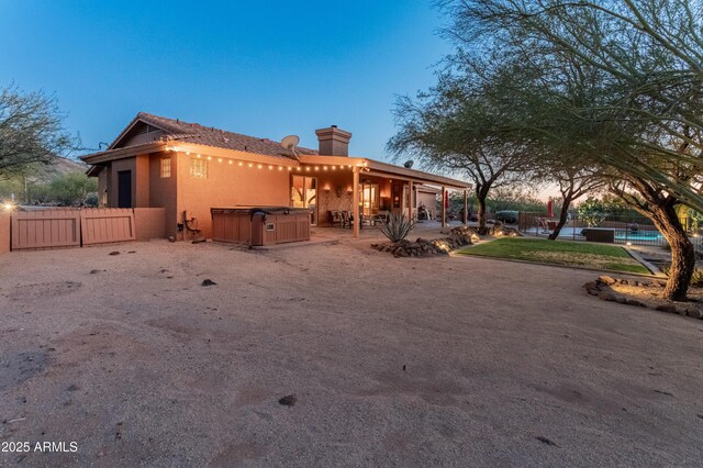 43638 N 22nd St, New River, AZ 85087 - view of front of property featuring a hot tub, a chimney, a patio, stucco siding, and a swimming pool