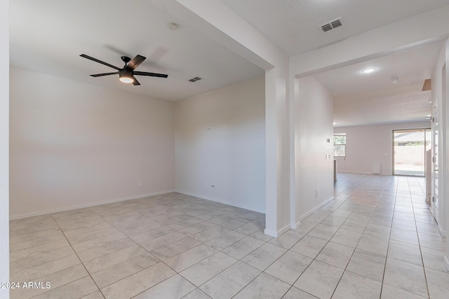 tiled spare room featuring ceiling fan