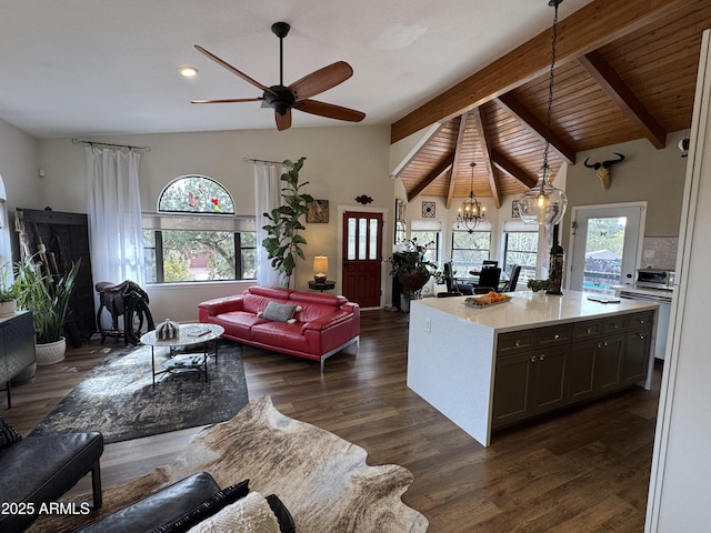 living room featuring ceiling fan with notable chandelier, vaulted ceiling with beams, dark hardwood / wood-style floors, and wood ceiling