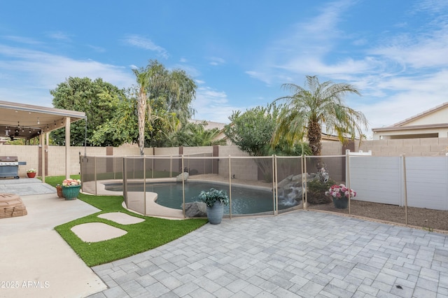 view of swimming pool featuring a patio and grilling area