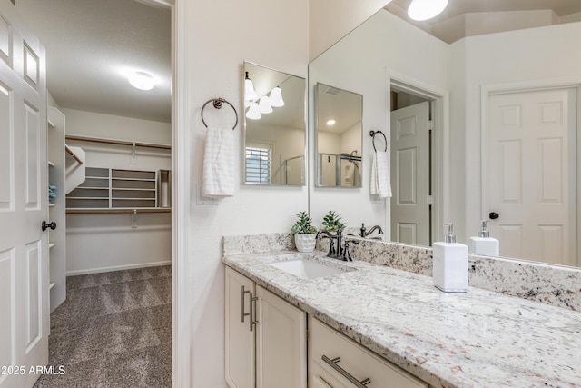 bathroom with vanity and a shower with shower door