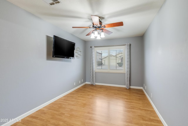 spare room featuring ceiling fan and light wood-type flooring