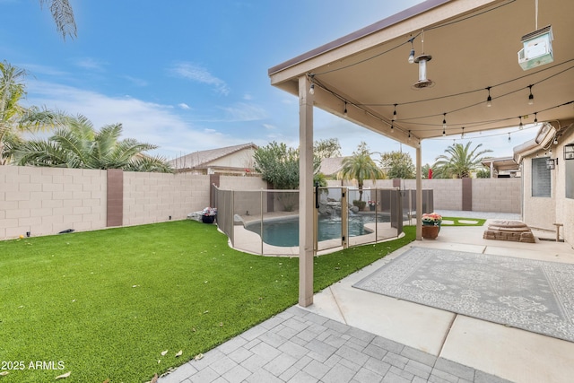 view of yard with a fenced in pool, an outdoor fire pit, and a patio area