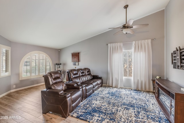 living room featuring vaulted ceiling, wood-type flooring, and ceiling fan