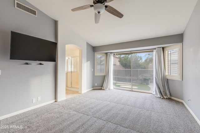 unfurnished living room featuring lofted ceiling, light colored carpet, and ceiling fan