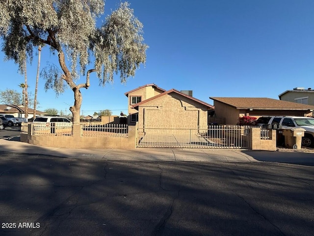 view of front of home featuring a fenced front yard and stucco siding