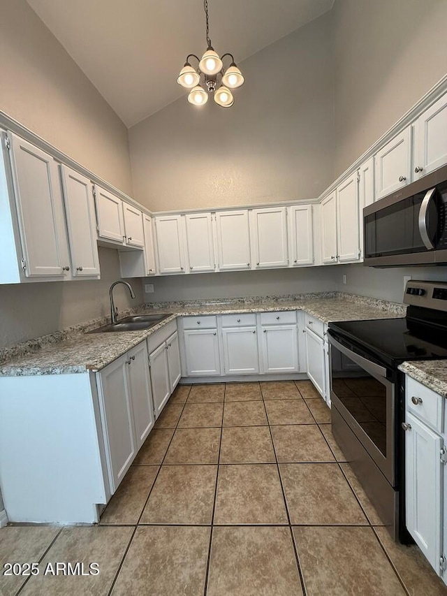 kitchen with high vaulted ceiling, light stone counters, stainless steel appliances, a sink, and white cabinetry